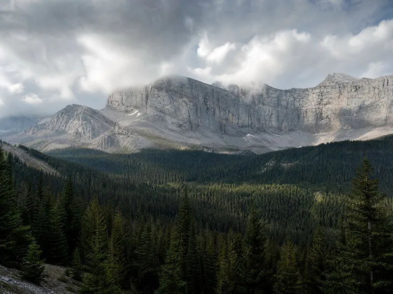 The limestone ridge above the treeline with cloud tearing off it
